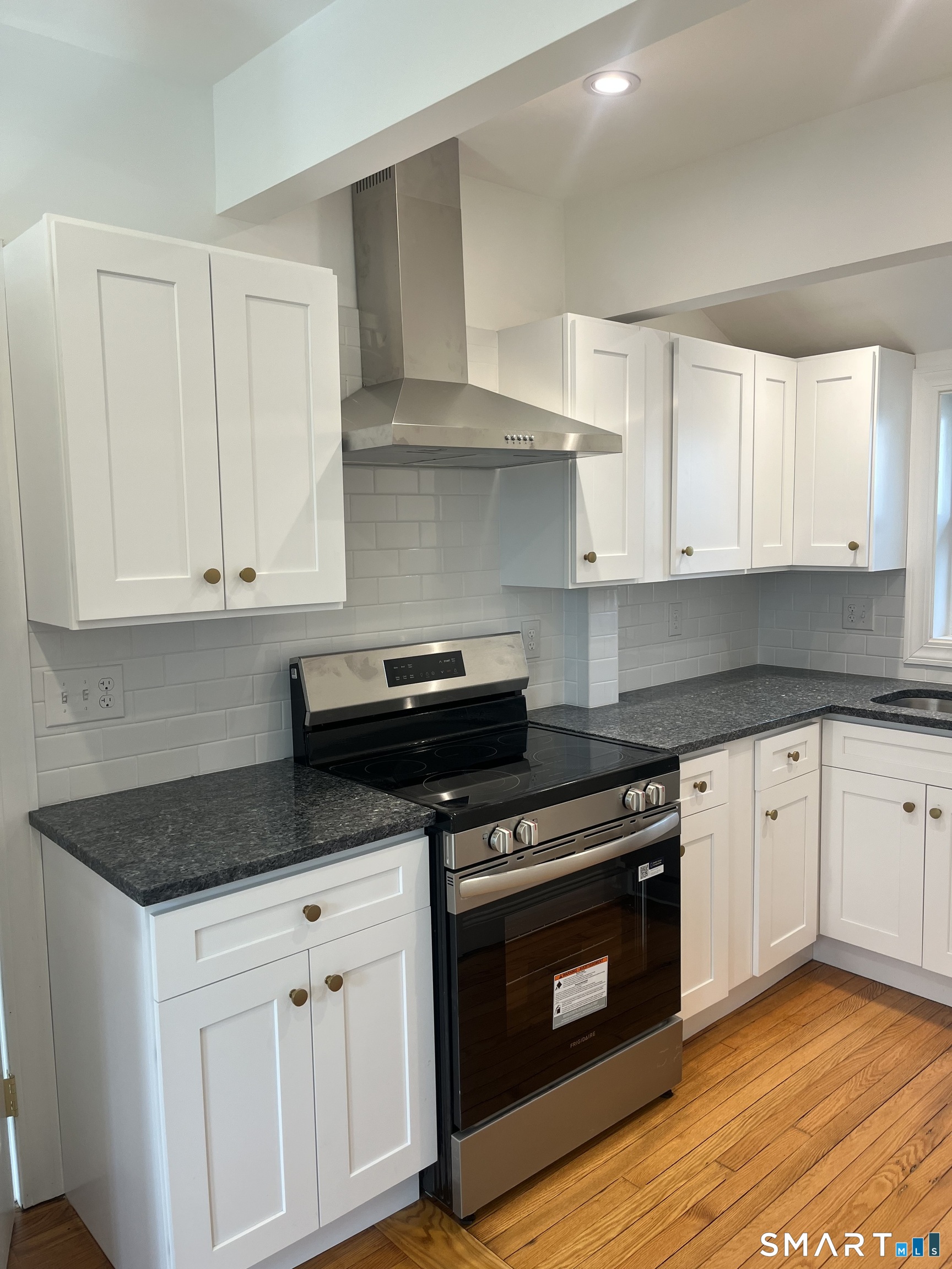 156 Union Street, Unit 2 Manchester, CT 06042 - Photo 4 of 16 a kitchen with granite countertop white cabinets and stainless steel appliances