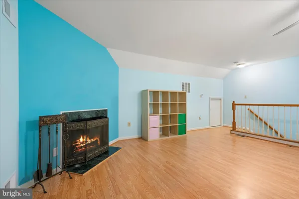 a bedroom with a bed and a fireplace