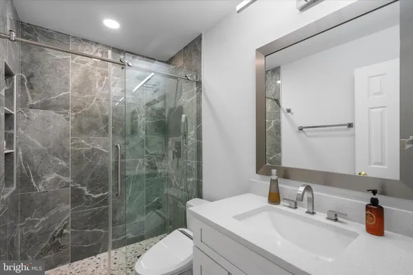 a bathroom with a sink toilet and shower