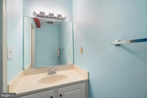 a bathroom with a sink and mirror
