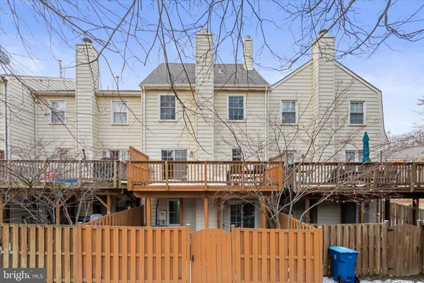 a view of a house with a wooden fence