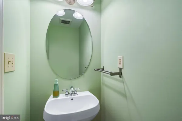 a bathroom with a sink and mirror
