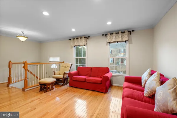 a living room with furniture window and a wooden floor