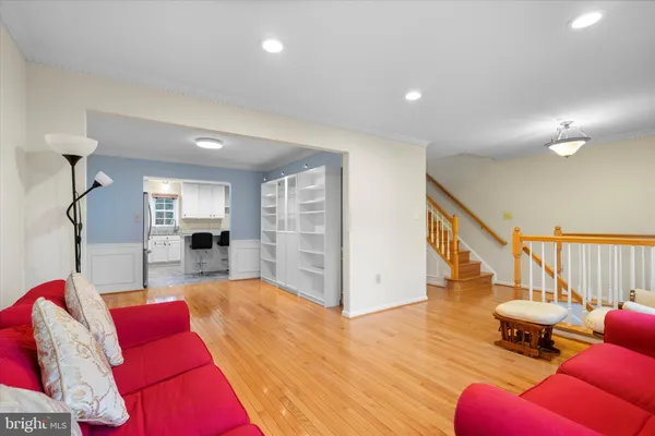 a living room with furniture or stairs and a wooden floor