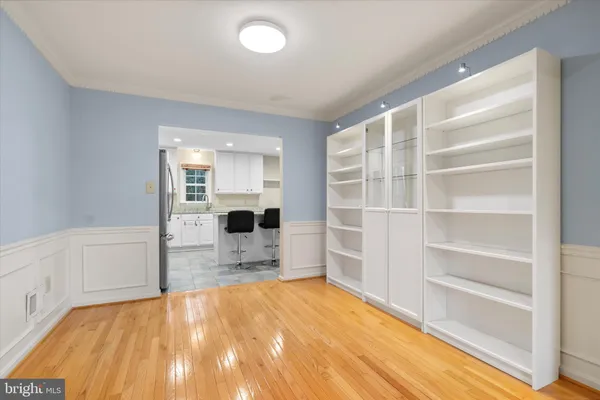 a view of empty room with a fireplace and wooden floor