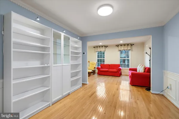 a bedroom with furniture and a wooden floor