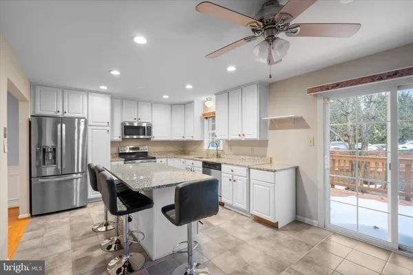 a kitchen with counter top space appliances and windows