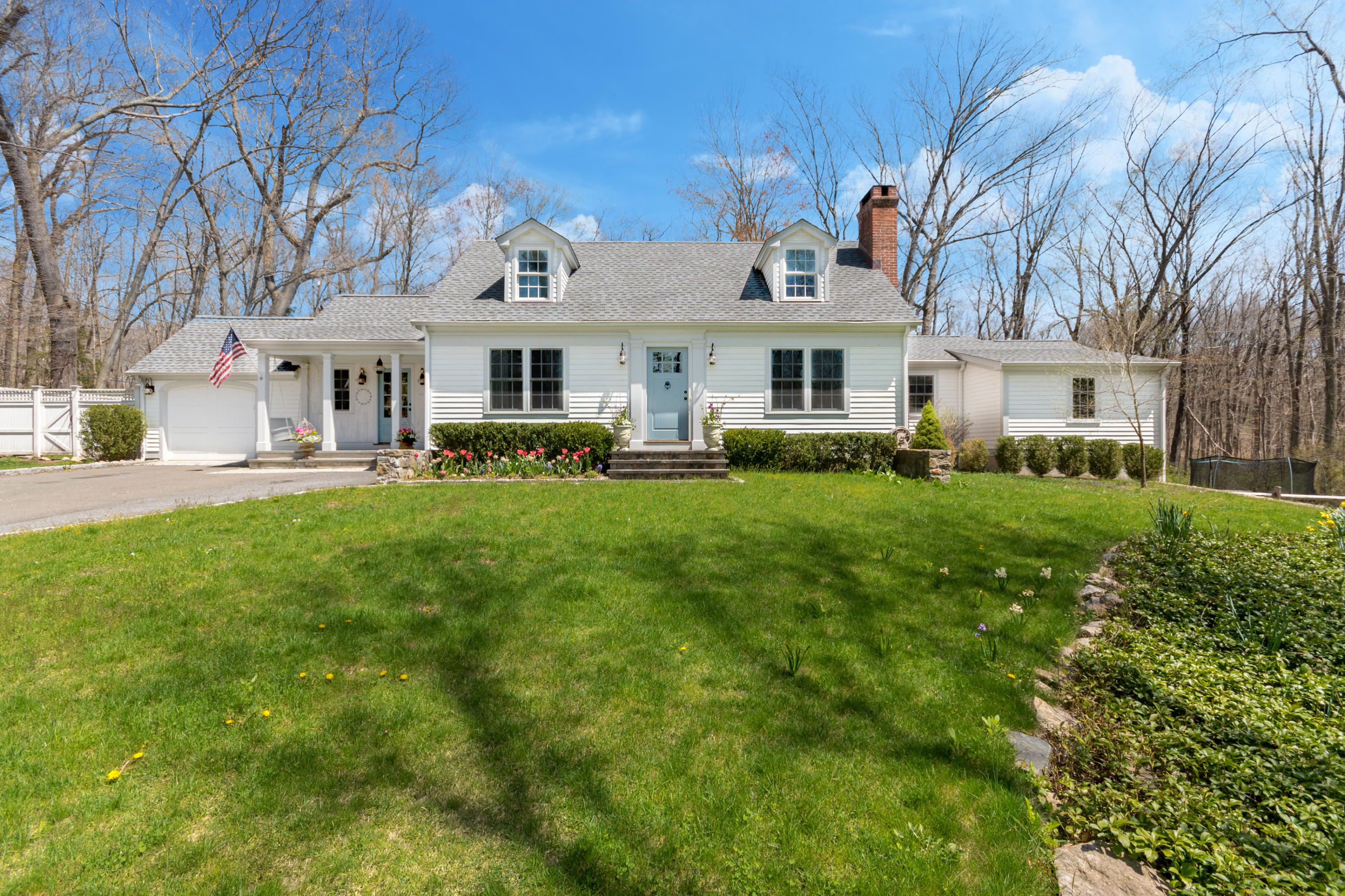 a front view of house with yard and green space