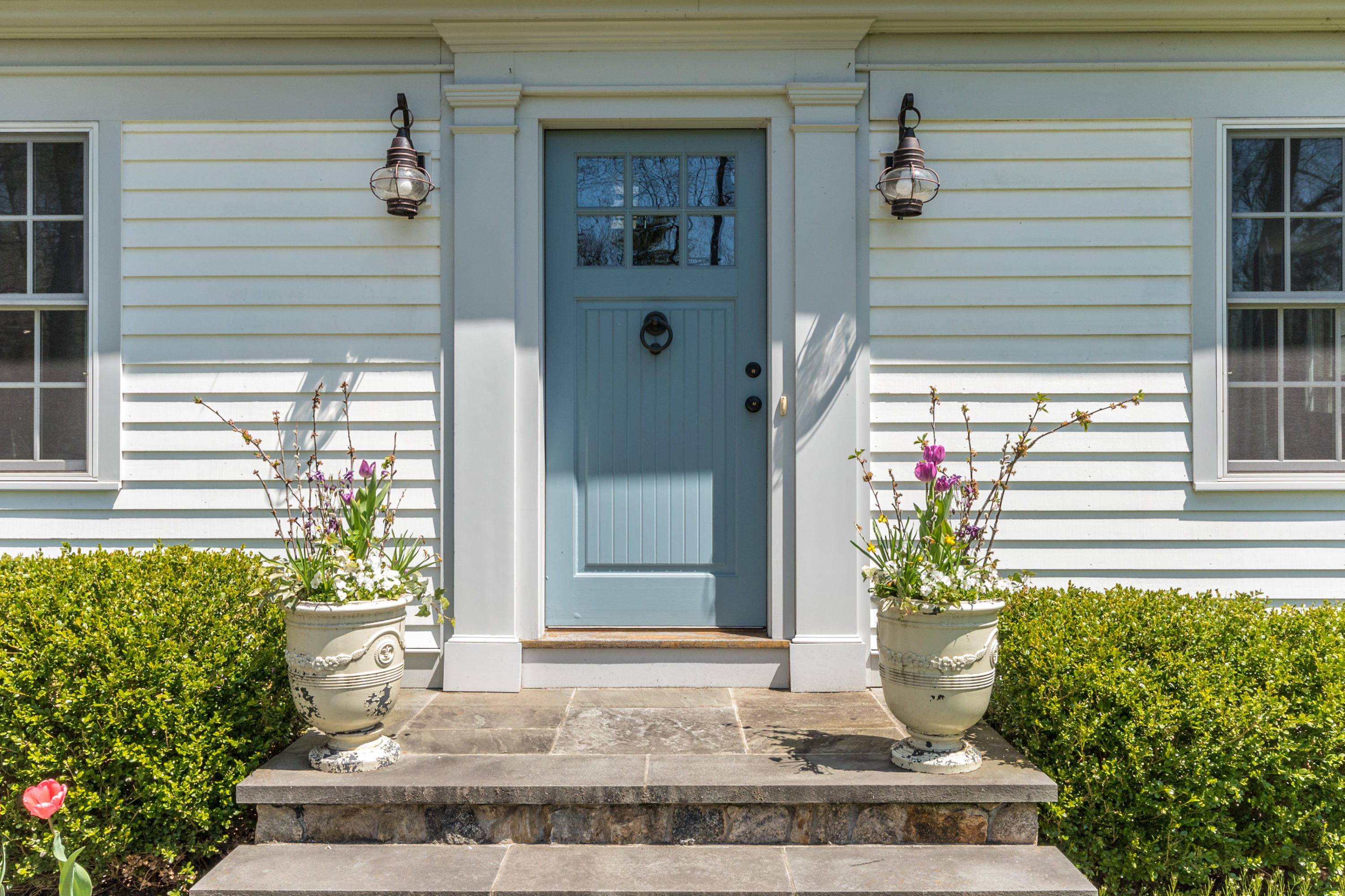 183 Smith Ridge Road New Canaan, CT 06840 - Photo 2 of 30 a front view of a house with plants