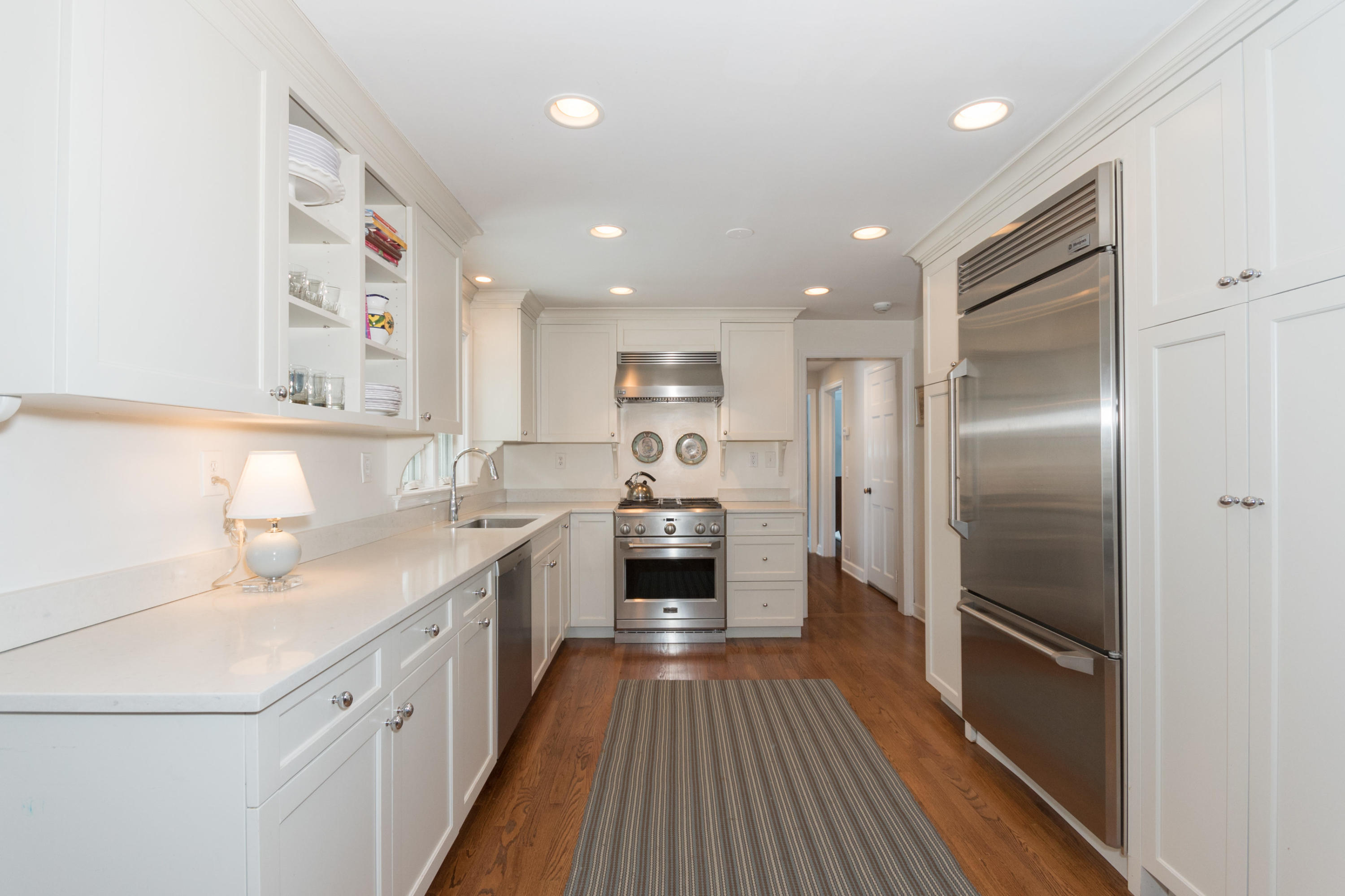 183 Smith Ridge Road New Canaan, CT 06840 - Photo 8 of 30 a kitchen with a refrigerator sink and cabinets
