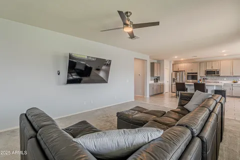 a kitchen with stainless steel appliances a table chairs sink microwave and cabinets