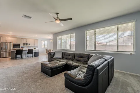 a kitchen with stainless steel appliances granite countertop a table chairs sink refrigerator and cabinets