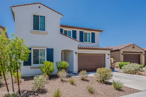 a view of a house with a door and wooden bench