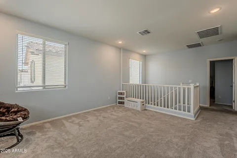 a view of a chair and tables in the balcony