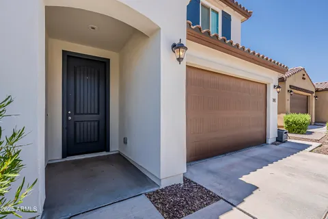 a view of a hallway with entryway and stairs