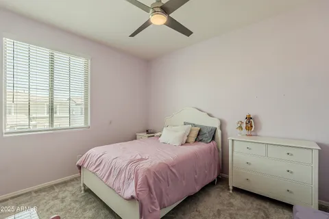 a front view of a house with a garden and fountain