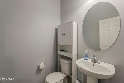 a living room with furniture and a view of kitchen