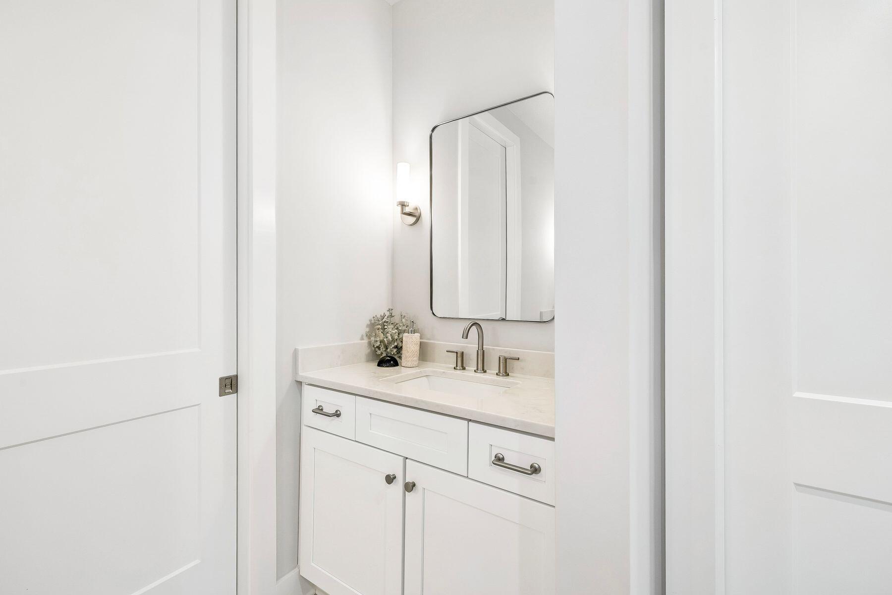 39 West Captain Fritz Way Freeport, FL 32439 - Photo 18 of 33 a bathroom with a sink and a mirror