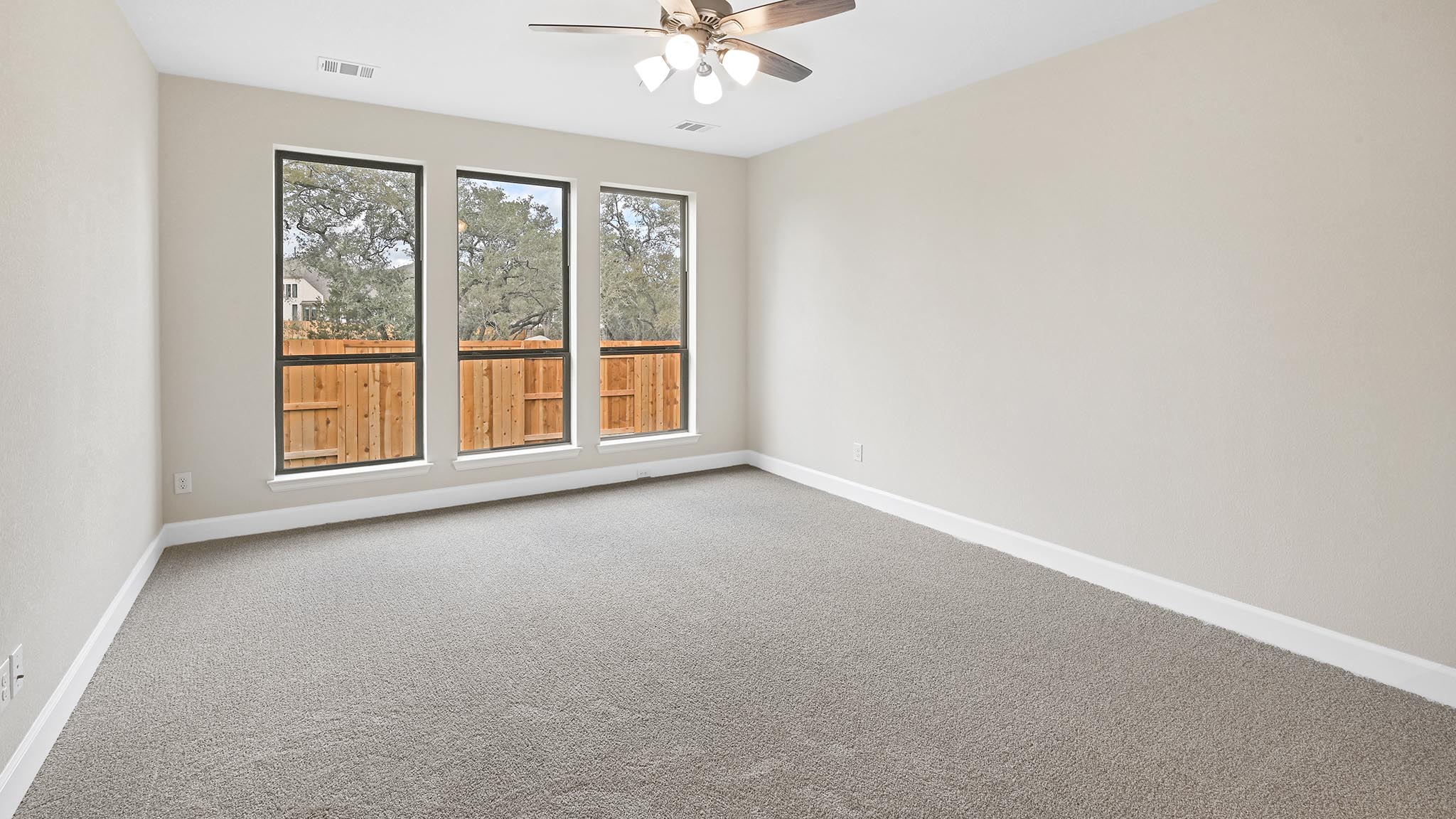 338 Prickly Poppy Loop Kyle, TX 78640 - Photo 9 of 40 Empty room featuring carpet flooring and a ceiling fan