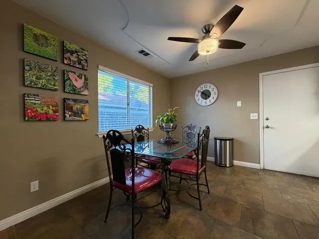 a view of a dining room with furniture and a large window
