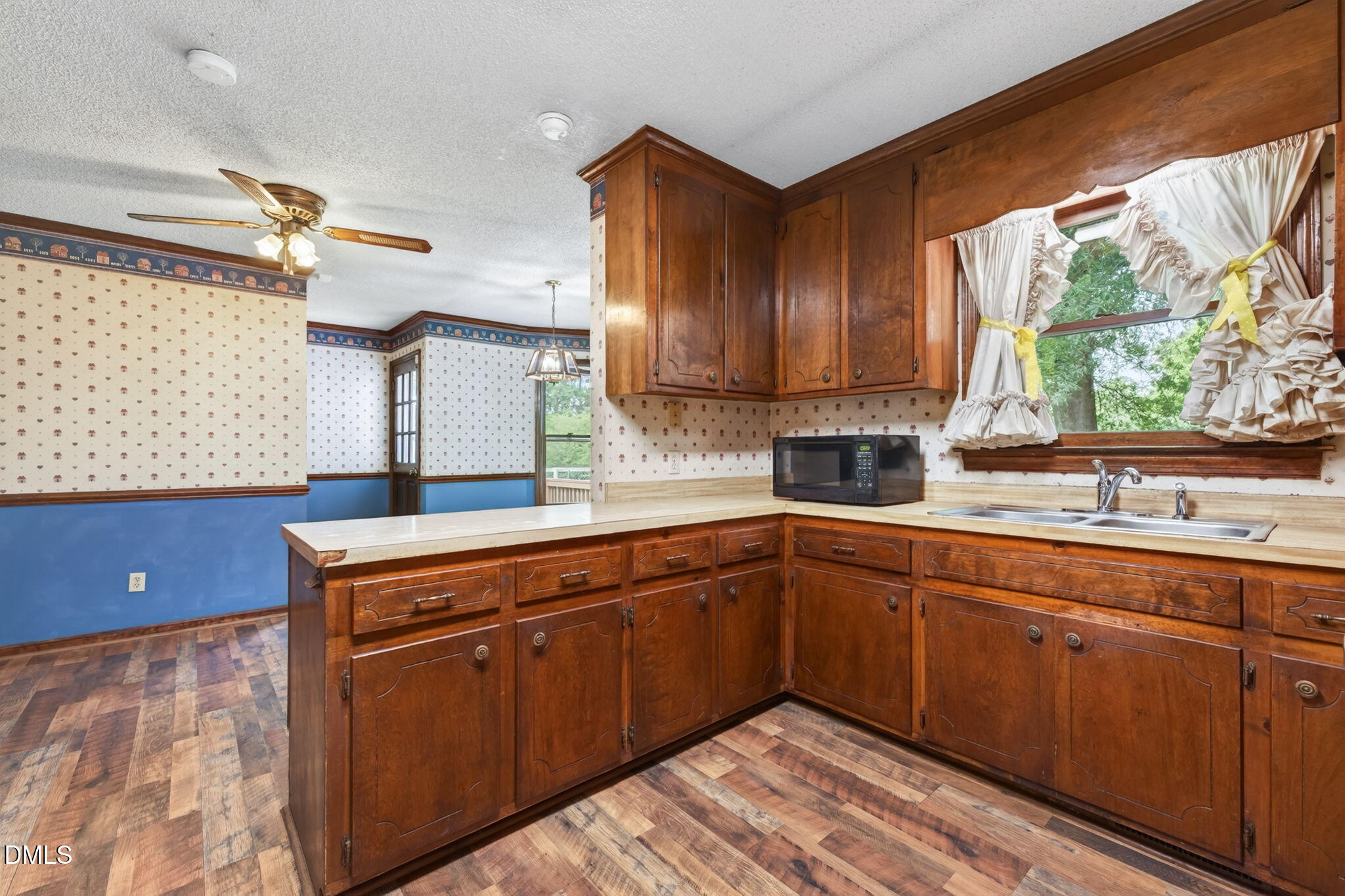 350 Grantham School Road Goldsboro, NC 27530 - Photo 12 of 49 a kitchen with stainless steel appliances granite countertop wooden cabinets a sink and a window