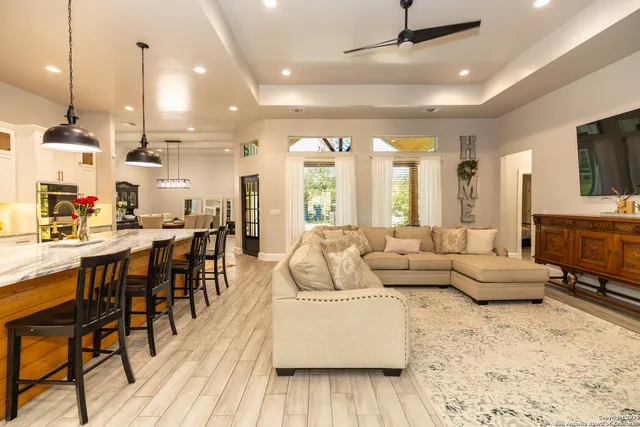 a kitchen with stainless steel appliances granite countertop a table chairs and a refrigerator