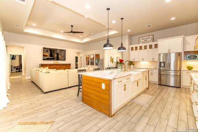 a large kitchen with stainless steel appliances kitchen island granite countertop a sink and cabinets
