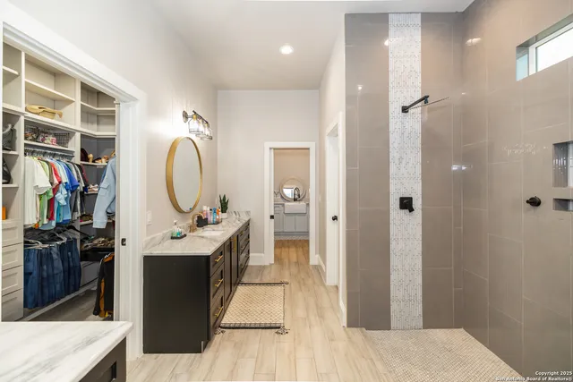 a bedroom with a bed and painting on the wall