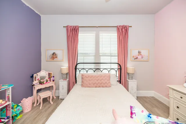 a living room with furniture and large windows