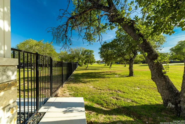 a view of a backyard with swimming pool