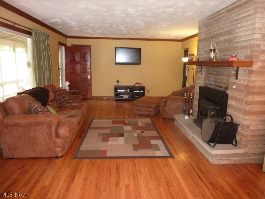 11597 Sperry Road Chesterland, OH 44026 - Photo 6 of 25 As You Enter from The Front Porch, the Welcoming Open Living and Dining Rooms Await Featuring a Stone, Raised Hearth, Woodburning Fireplace with Insert .... Great Additional Heat Source!