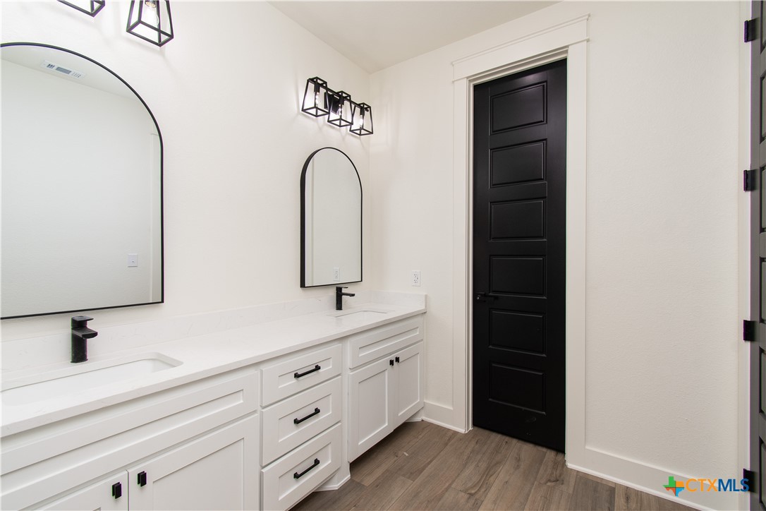 4245 Stringtown Road Temple, TX 76501 - Photo 12 of 25 a bathroom with a double vanity sink and mirror
