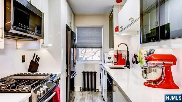 a kitchen with a sink appliances and cabinets