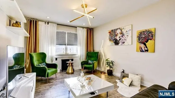 a living room with fireplace furniture and a large window