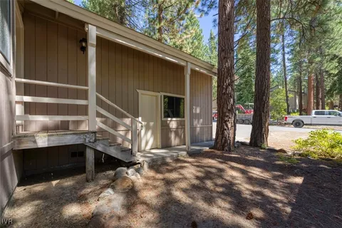 a view of a house with a large tree