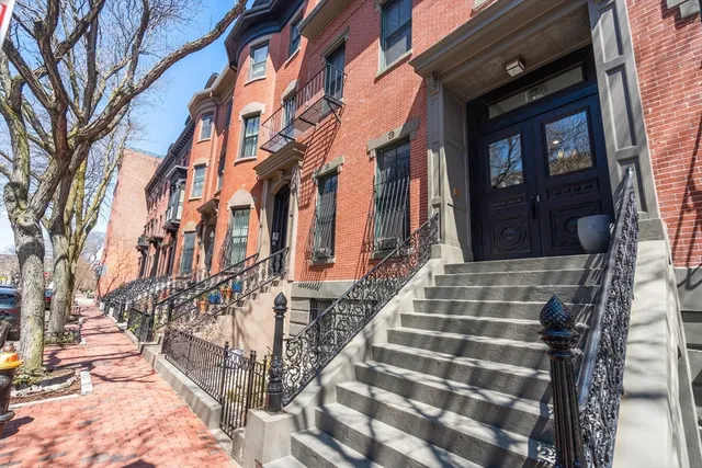 a view of a brick building with many windows