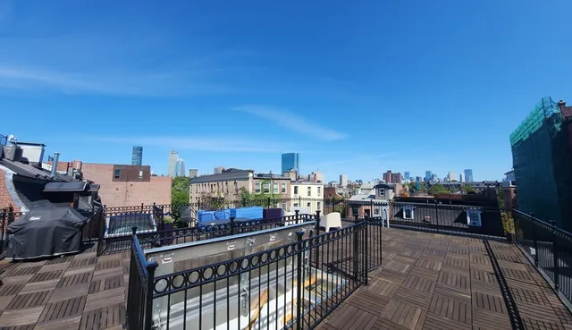 a view of a balcony with wooden benches