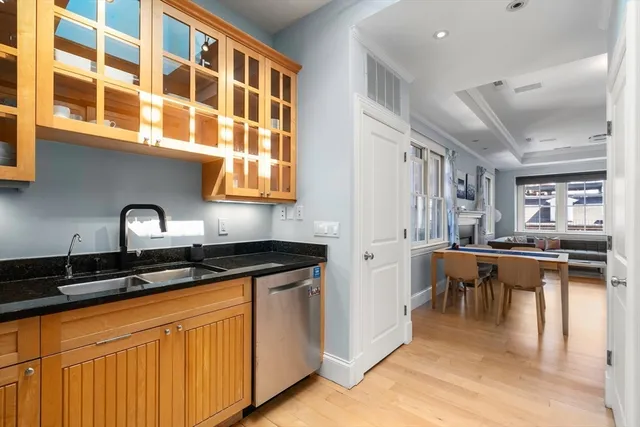 a kitchen with stainless steel appliances granite countertop a sink and cabinets