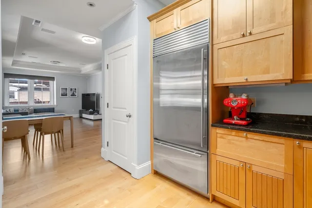 a kitchen with stainless steel appliances granite countertop a refrigerator and a stove top oven