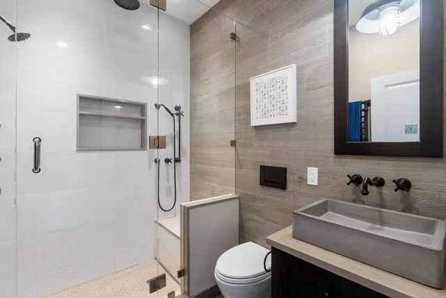 a bathroom with a toilet sink and shower