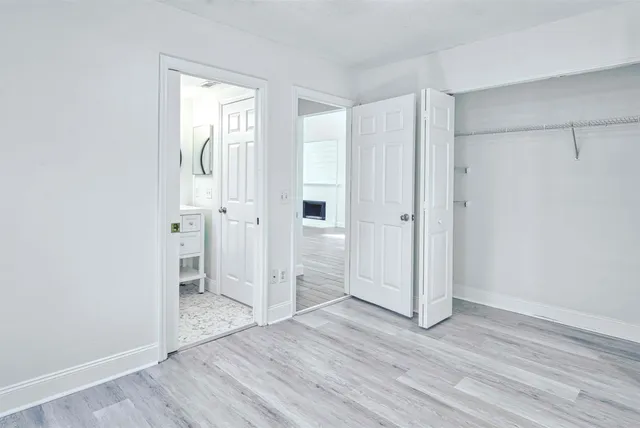 an empty room with wooden floor