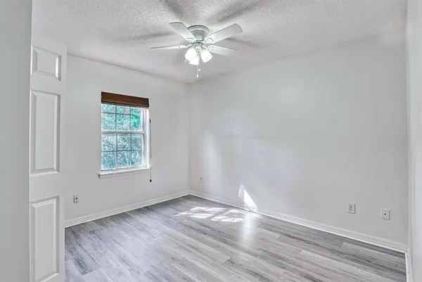 a view of hallway with wooden floor