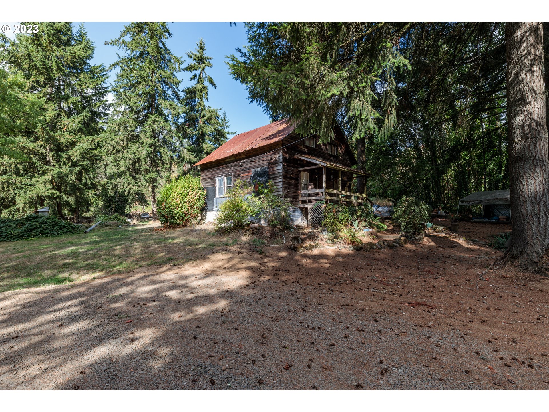 70341 Nicolai Road Rainier, OR 97048 - Photo 3 of 10 a view of a wooden house with a yard