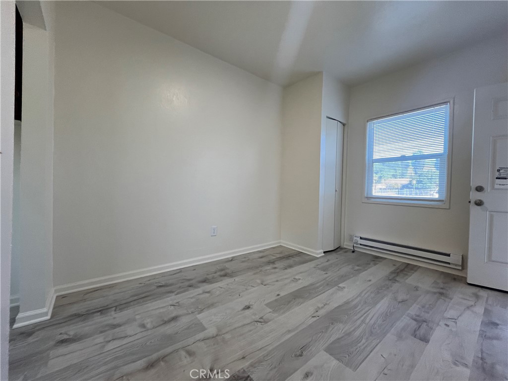 24601 1/2 Richman Drive Loma Linda, CA 92354 - Photo 4 of 13 an empty room with wooden floor and windows