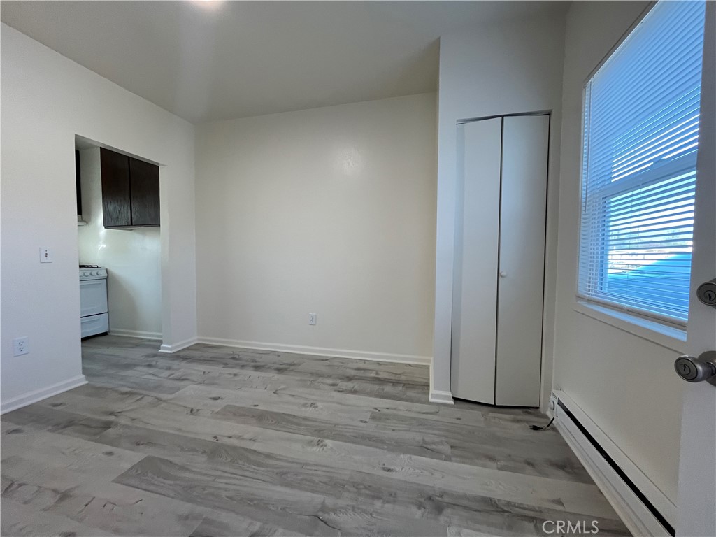 24601 1/2 Richman Drive Loma Linda, CA 92354 - Photo 5 of 13 a view of an empty room with wooden floor and a window