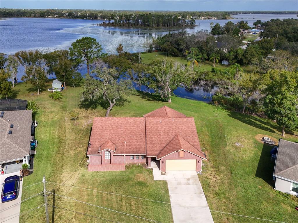2161 Vance Road Deltona, FL 32738 - Photo 1 of 1 an aerial view of a house with a yard and lake view