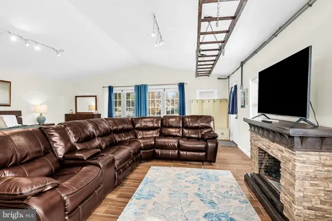 a living room with furniture flat screen tv and a dining table