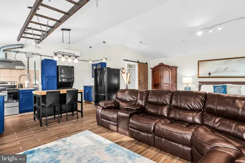 a dining room with a wooden table and chairs