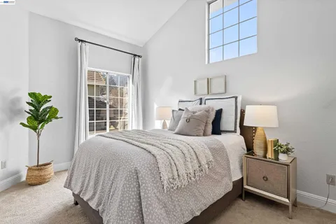 a bedroom with bed and a potted plant