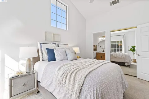 a spacious bedroom with a bed and window